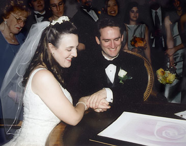 Daniel Sroka of Modern Ketubah and his wife signing the ketubah he made for their wedding.