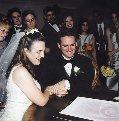 Daniel Sroka of Modern Ketubah and his wife signing the ketubah he made for their wedding.